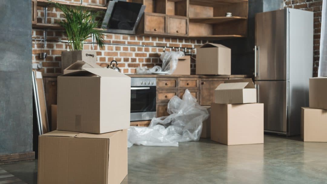 Cardboard boxes in an empty kitchen during relocation